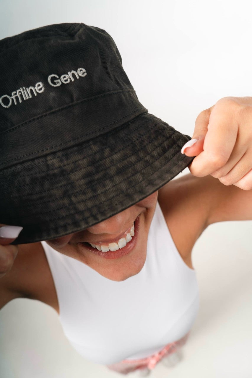 Person wearing a black bucket hat with 'Offline Gene' text, smiling.
